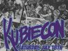 Kubie Con 2026 Returns on July 18th Overhead view of sneakers on a floor covered with comic books. The text "Kubiecon" and "Saturday, July 18th" is prominently displayed in bold letters.