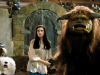 SF – Celebrate 40 Years of Labyrinth | Aug 22nd A young woman stands next to a large horned creature and two fantasy animals in front of a stone door in a fantasy setting.