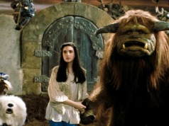 SF – Celebrate 40 Years of Labyrinth | Aug 22nd A young woman stands next to a large horned creature and two fantasy animals in front of a stone door in a fantasy setting.