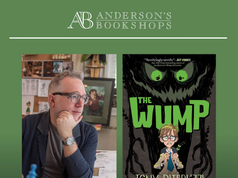 IL – The Wump Signing | Oct 4th Author Tony DiTerlizzi sits at a desk beside the cover of his book “The Wump.” Event details: October 4 at 2pm, Anderson’s Bookshops.